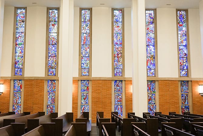 Elegant church sanctuary with stained glass windows, ideal for weddings and gatherings.