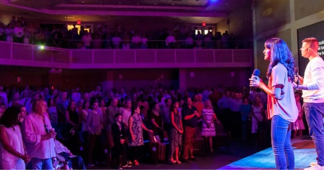 Speaker engaging audience at Highland Park UM Church event, showcasing connection and enthusiasm.