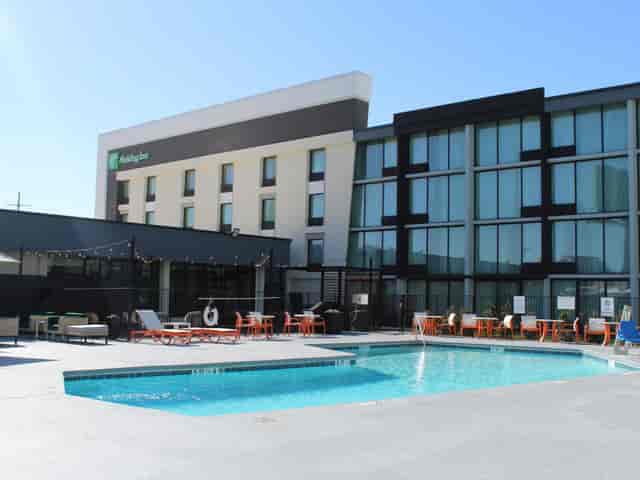 Modern Staybridge Suites Business Center with inviting pool for networking events.