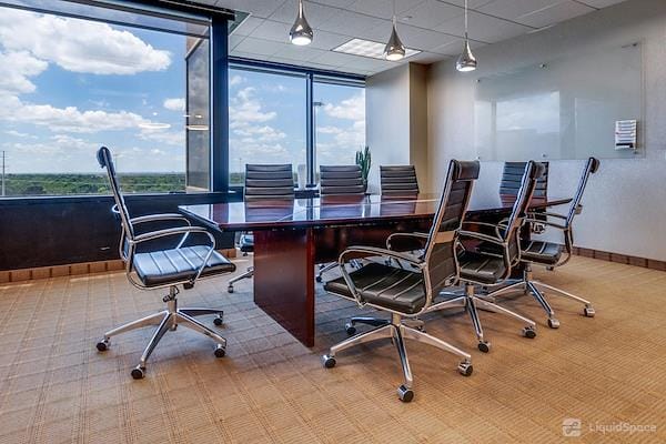 Modern conference room with wooden table and ergonomic chairs for productive meetings.