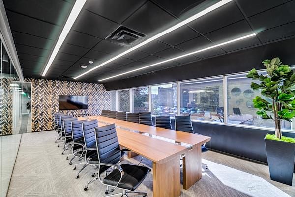 Modern conference room with ergonomic chairs for corporate meetings and presentations.