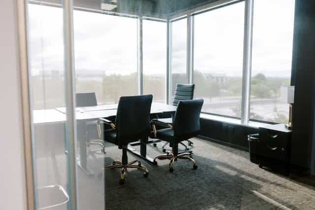 Modern conference room with large windows for meetings and events in Lucid Private Offices.