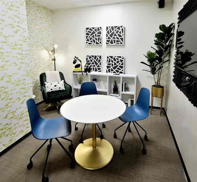 Modern meeting room with green chair for creative collaborations and brainstorming sessions.