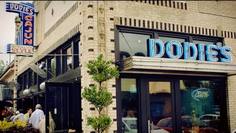 Dodie's Reef restaurant exterior with neon signage for casual events and Cajun cuisine.