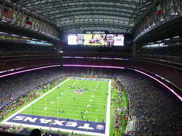 NRG Stadium, vibrant venue for concerts and events, features expansive field and overhead screen.