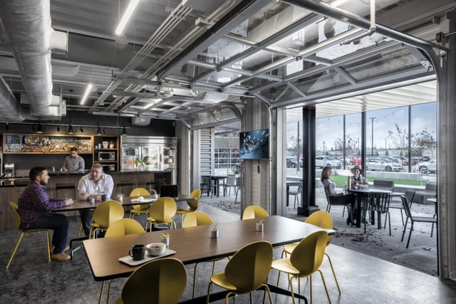 Modern event space with flexible seating and natural light, ideal for meetings and networking.