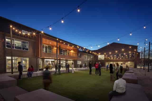 Stylish outdoor theater venue with string lights, ideal for receptions and networking events.