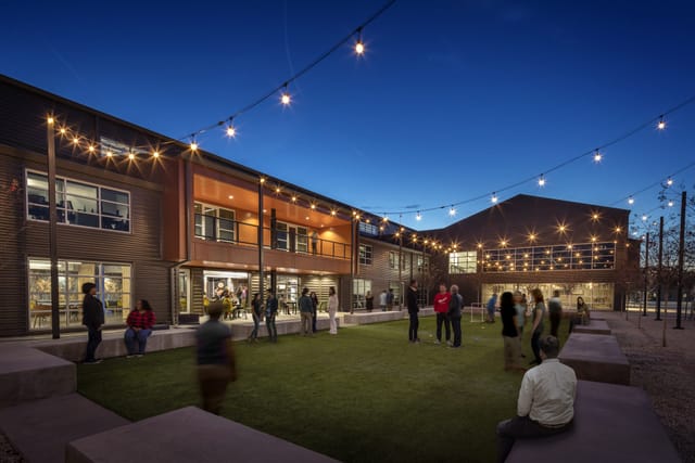 Stylish outdoor theater venue with string lights, ideal for receptions and networking events.