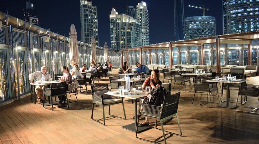 Rooftop restaurant in Burj Khalifa with modern seating, ideal for networking events and private dinners.