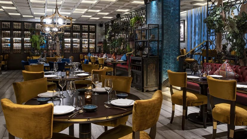 Semi-private dining area at COYA Doha, featuring stylish tables and elegant decor.