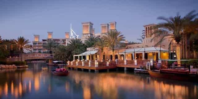 Elegant waterfront venue Pai Thai with palm trees, ideal for corporate events and gala dinners.