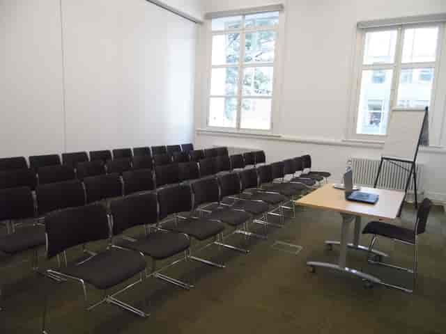 F13 Meeting Room at Friends' Meeting House, bright setup for workshops and presentations.