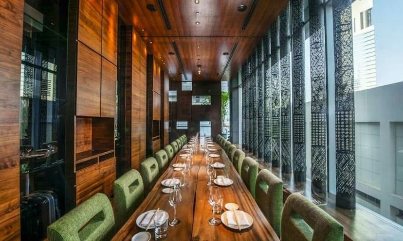 Private dining room in Zuma with large windows for corporate meetings and upscale events.
