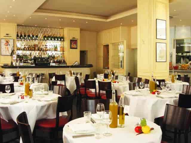 Elegant dining setup at La Petite Maison bar for corporate events and intimate gatherings.