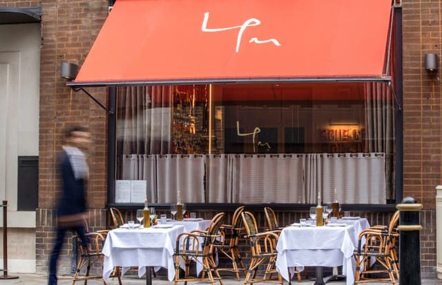 Chic dining room with vibrant awning, ideal for networking events and meetings.