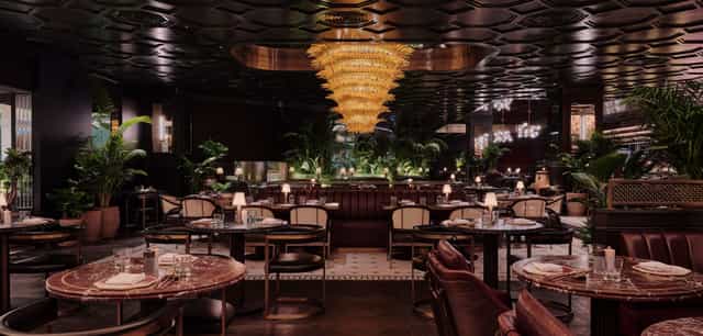 Elegant restaurant venue for upscale corporate events with a luxurious chandelier.