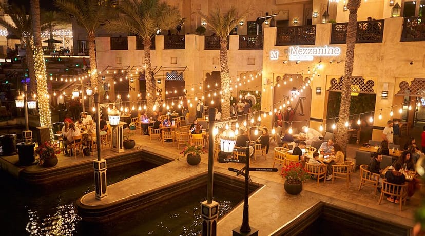 Outdoor garden dining at Emirates Sports Complex with palm trees, ideal for events.
