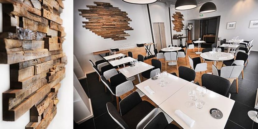 Modern restaurant interior with wood accent wall, ideal for corporate lunches and celebrations.
