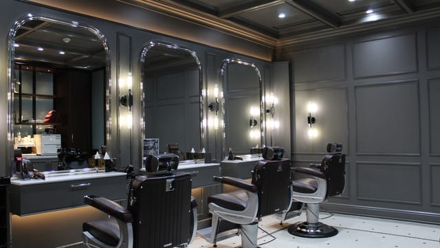 Sleek barbershop interior at The Lunatic Fringe for networking and grooming events.