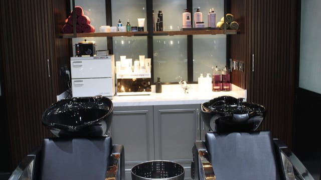 Sleek salon interior with shampoo stations for luxury corporate retreats and wellness events.