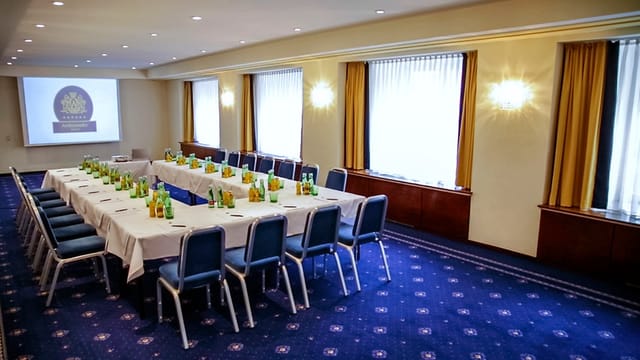 Meeting Room 3 at Hotel Ambassadeur, featuring a long table setup for professional events.