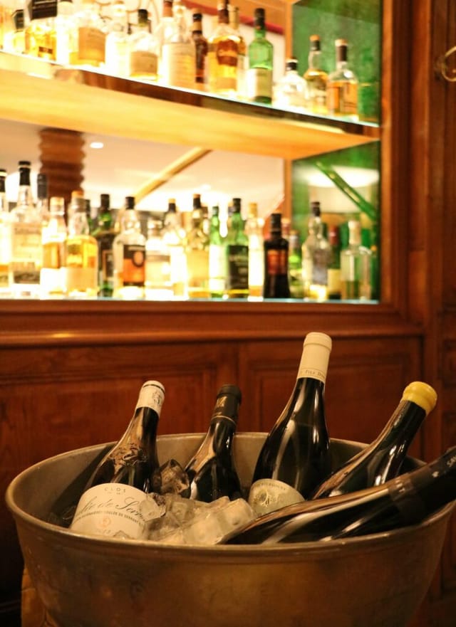 Wine bottles in a chilled bucket at Salon de Dégustation, ideal for networking events.