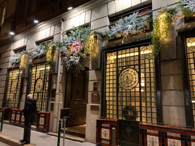 Elegant winter event venue entrance at La Mère Brazier with intricate window design.