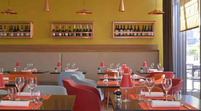 Modern bistro with colorful decor, ideal for events and gatherings in Le Rive Gauche.