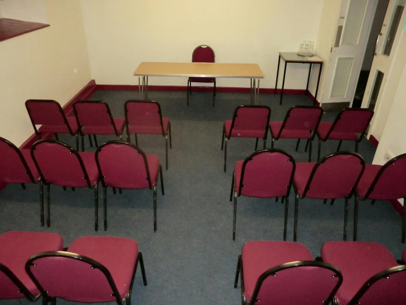 G4 meeting room in Friends' Meeting House with maroon chairs for small gatherings.