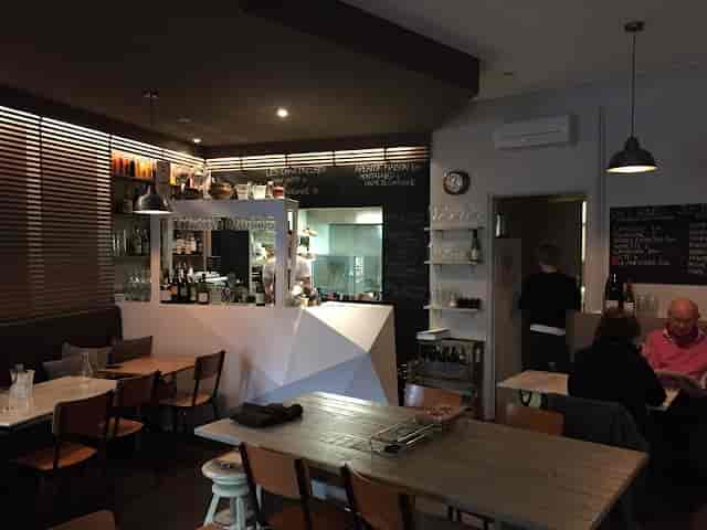 Cozy Bistro setting with inviting bar for intimate meetings and casual gatherings.