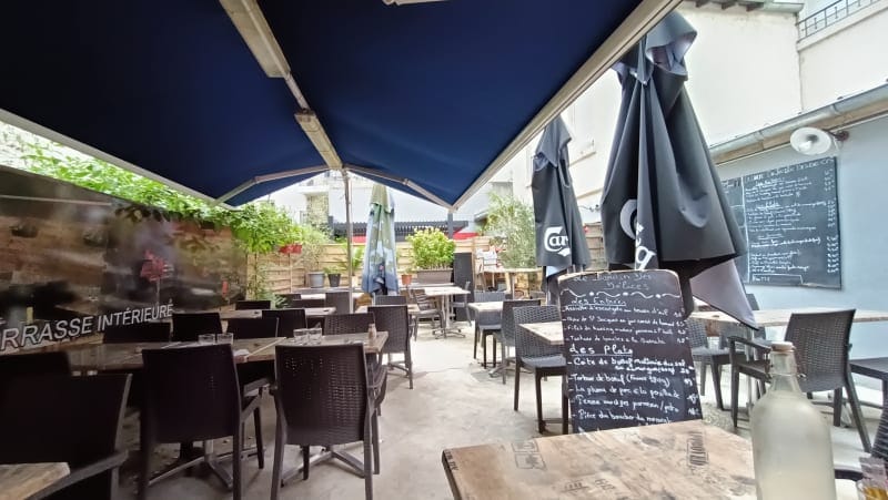 Outdoor venue with cozy patio seating for casual meetings or al fresco events.