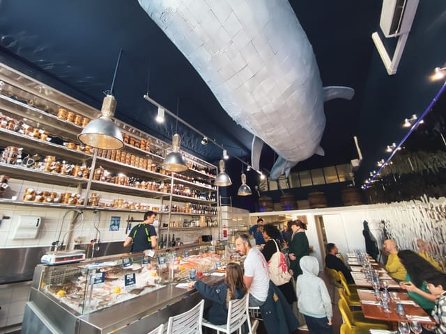 Seafood restaurant with whale ceiling art, perfect for private or corporate gatherings.
