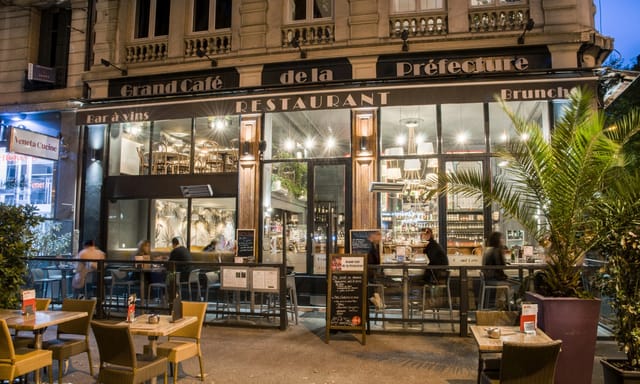 Chic restaurant exterior with outdoor seating for networking mixers and casual meetings.