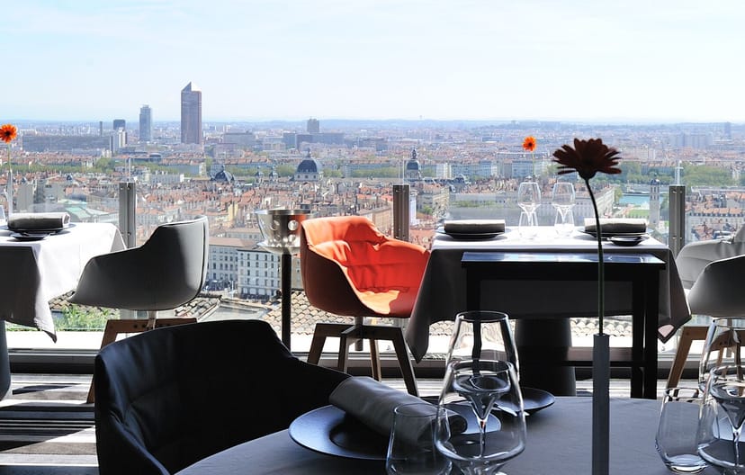 Sophisticated Le Rooftop Têtedoie dining area with panoramic views for upscale events.