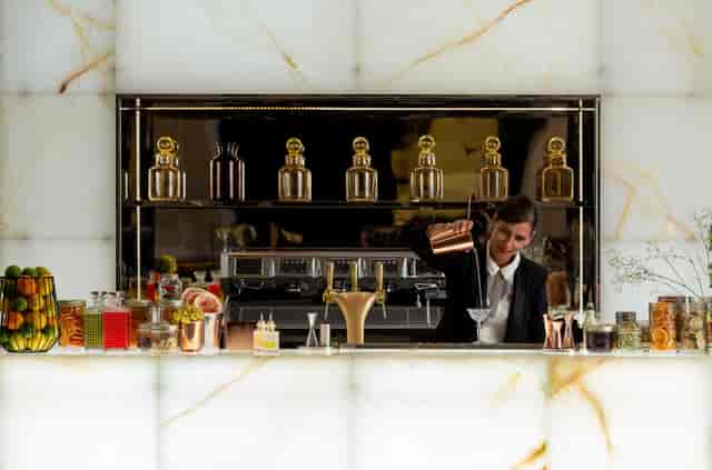 Elegant bartender crafting cocktails at InterContinental Lyon's upscale event bar.