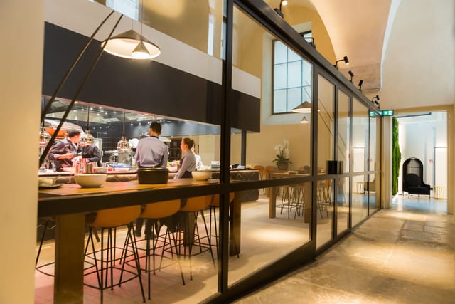 Modern meeting space with glass walls, ideal for networking events and gatherings.