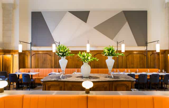 Modern dining space at L’Officine with geometric art, ideal for upscale events.