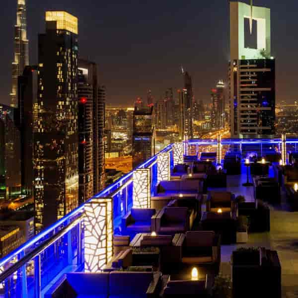 Rooftop terrace with blue lighting, perfect for upscale corporate events and receptions.