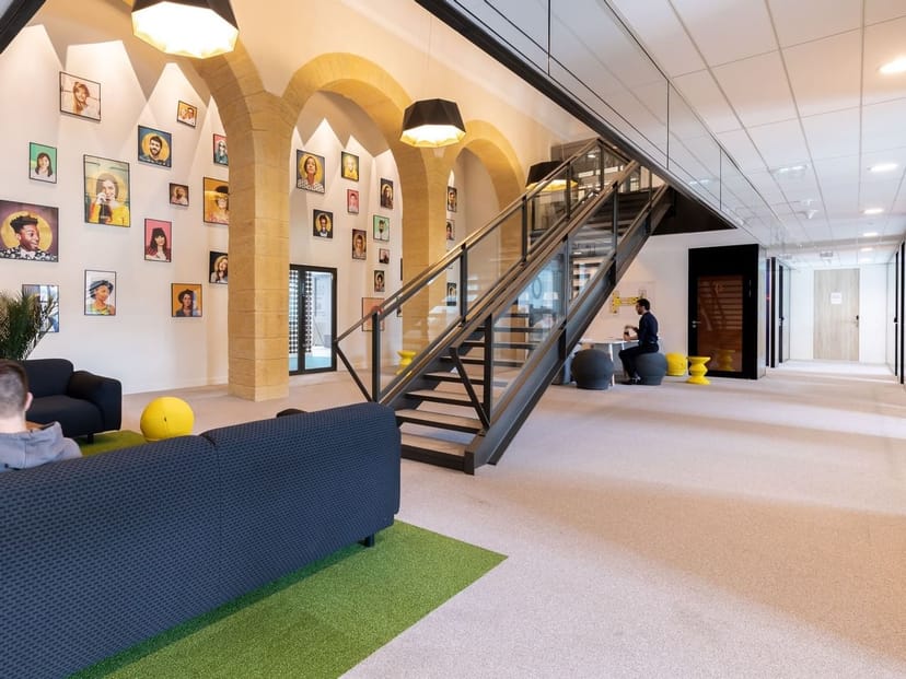 Modern conference center lobby in Lyon, featuring inviting seating and creative artwork.