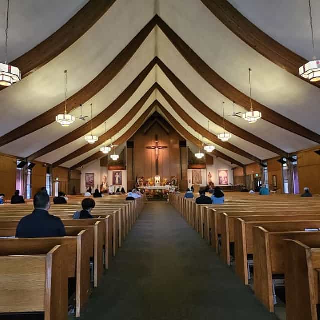 Fellowship Hall interior, wooden pews, ideal for spiritual gatherings and community events.