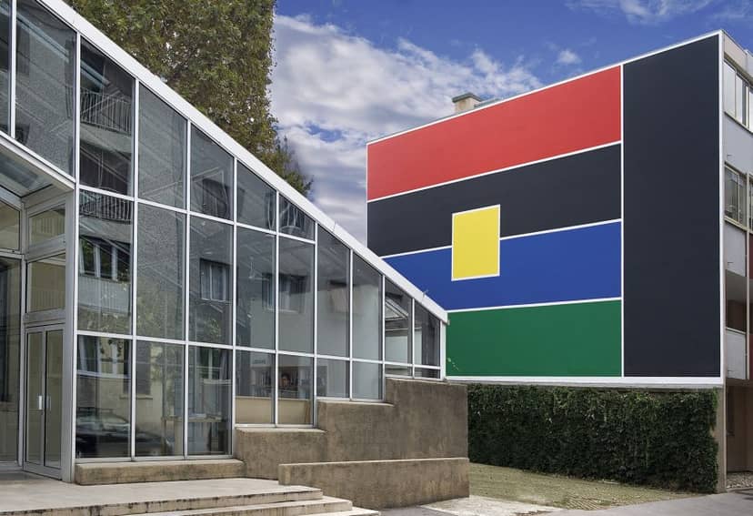 Modern auditorium with glass architecture, vibrant mural for contemporary events.