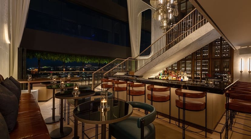 Sophisticated venue with elegant seating and cityscape view for upscale events.