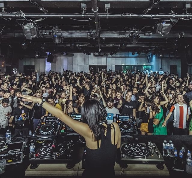 Vibrant nightlife event at Le Sucre's Salle de concert with DJ performance.