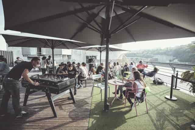 Rooftop event space at Le Sucre with seating and foosball for corporate networking.