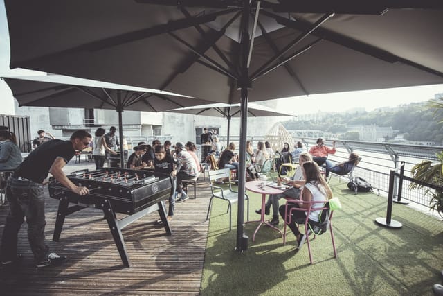 Rooftop event space at Le Sucre with seating and foosball for corporate networking.