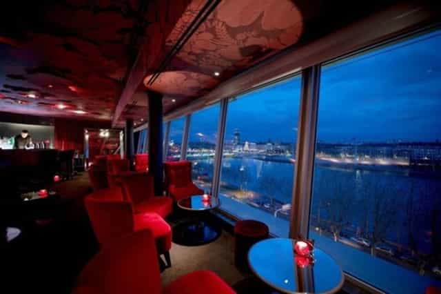 Stylish event space at Sofitel Lyon Bellecour with red seating for cocktail receptions.