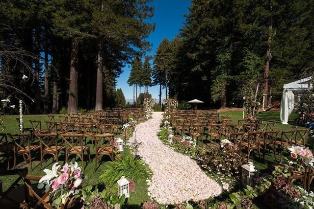 Outdoor wedding ceremony setup at The Mountain Terrace with floral path and greenery.