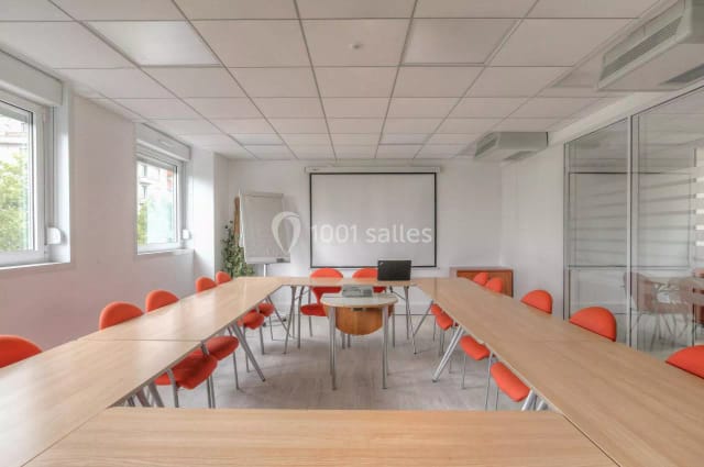 Modern training room with vibrant orange chairs, perfect for workshops and meetings.