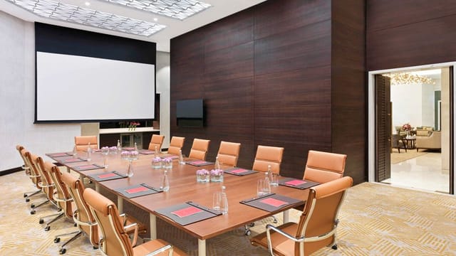 Modern meeting room at Sofitel Dubai with sleek table, ideal for corporate events.