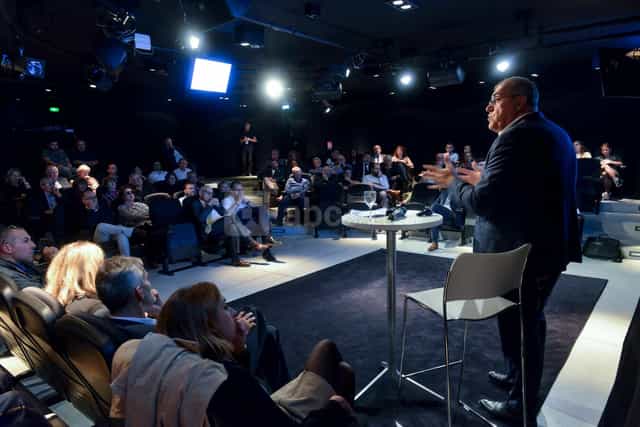 Grand Auditorium event with engaged audience and speaker in modern Musée des Confluences.